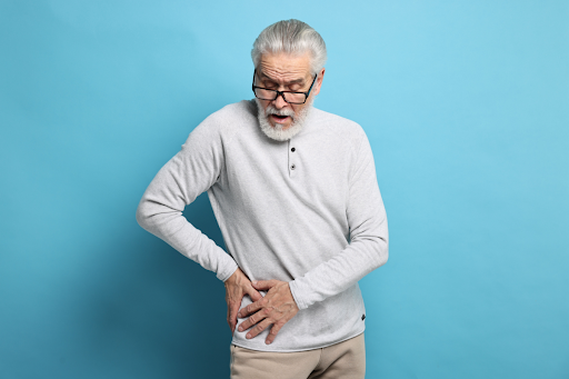 An old man feeling hip pain