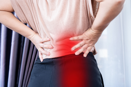 Woman feeling sciatica pain in her back